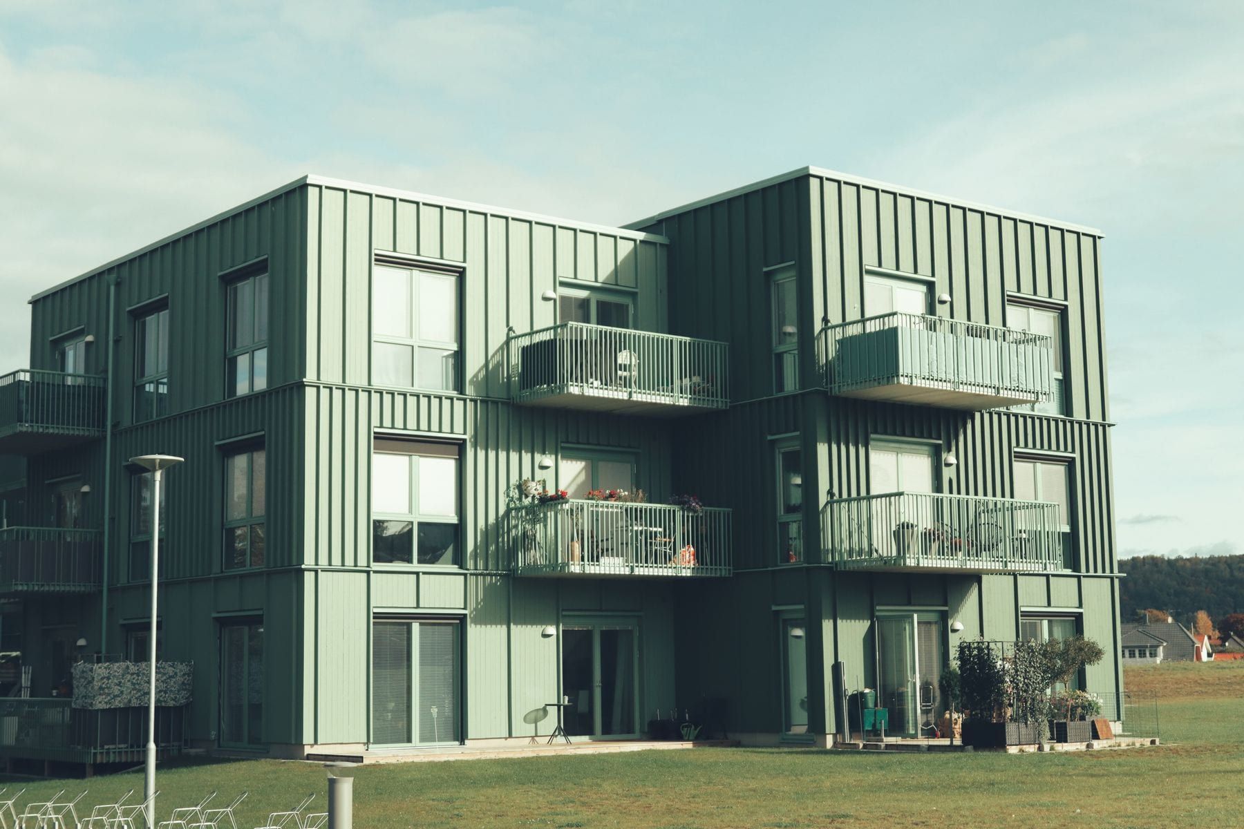 Apartment building with a green facade and balconies