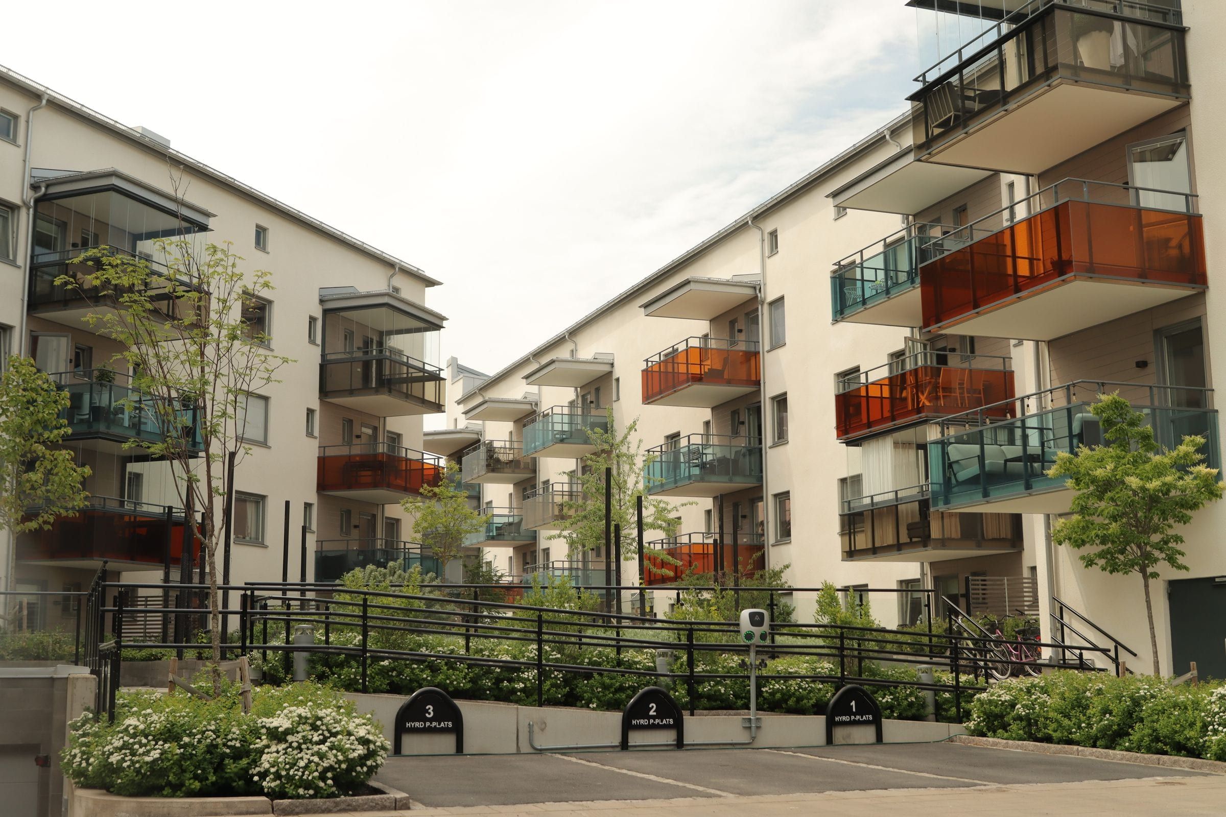 Modern apartment buildings with balconies and a planted courtyard
